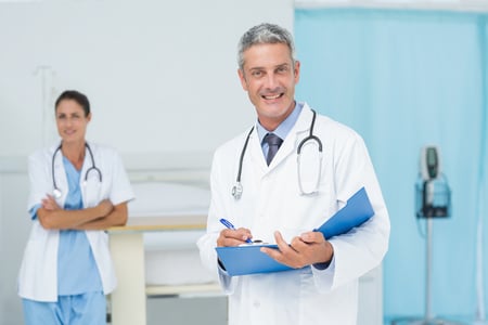 Male and female doctors working on reports in the hospital